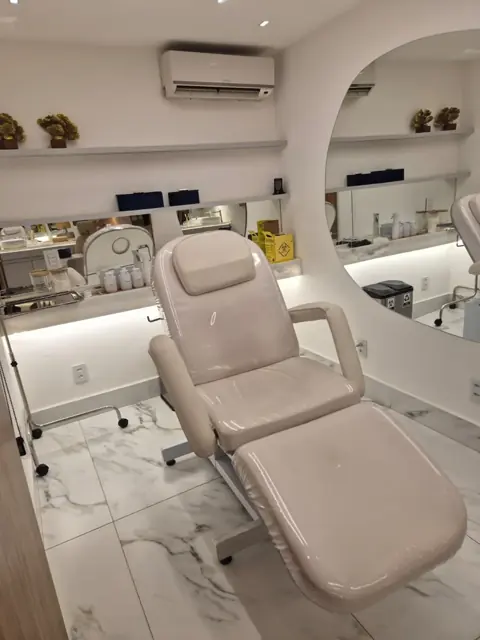 Sala de procedimentos com cadeira e espelho